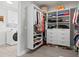 Spacious walk-in closet with custom shelving, drawers, and laundry area at 5823 Title Row Dr, Bradenton, FL 34210