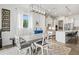 Bright dining room featuring a large table, modern chandelier, and view of the kitchen at 5823 Title Row Dr, Bradenton, FL 34210