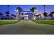 IMG Academy exterior featuring palm trees, manicured lawn, and state-of-the-art building design at dusk at 5823 Title Row Dr, Bradenton, FL 34210