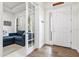 Bright foyer showcasing light wood flooring, a white front door with glass, and a glimpse into a living room at 5823 Title Row Dr, Bradenton, FL 34210