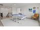 Spacious game room featuring a ping pong table, neutral carpet, and a comfortable chair at 5823 Title Row Dr, Bradenton, FL 34210