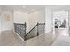 Upstairs hallway with decorative railing with view into the primary bedroom at 5823 Title Row Dr, Bradenton, FL 34210