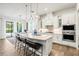 Modern kitchen with a large island, pendant lighting, stainless steel appliances, and breakfast bar at 5823 Title Row Dr, Bradenton, FL 34210