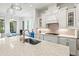 Modern kitchen featuring a large island with quartz countertop and breakfast bar at 5823 Title Row Dr, Bradenton, FL 34210