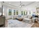 Spacious living room with large windows, sectional sofa, and hardwood floors throughout at 5823 Title Row Dr, Bradenton, FL 34210