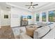 Bright living room with wood-look flooring, large windows, and a comfortable sectional sofa at 5823 Title Row Dr, Bradenton, FL 34210