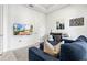 Bright living room showcasing a blue sectional sofa, a wall-mounted TV, and a desk with office space at 5823 Title Row Dr, Bradenton, FL 34210