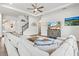 Spacious living room with wood-look floors, a staircase, and a comfortable sectional sofa bathed in natural light at 5823 Title Row Dr, Bradenton, FL 34210