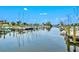 Scenic marina view with numerous sailboats docked along a calm canal under a partly cloudy sky at 5823 Title Row Dr, Bradenton, FL 34210