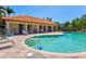 Community pool features a spa, lounge chairs, and a covered seating area at 5823 Title Row Dr, Bradenton, FL 34210