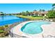 Beautiful community pool with waterfront views surrounded by lush landscaping and comfortable lounge chairs at 5823 Title Row Dr, Bradenton, FL 34210