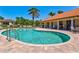 Community pool with lounge chairs and umbrellas, perfect for relaxation and recreation at 5823 Title Row Dr, Bradenton, FL 34210