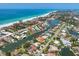 Scenic aerial view showcasing waterfront homes with boat docks, pools, and ocean access at 5920 Gulf Of Mexico Dr, Longboat Key, FL 34228