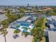 Stunning aerial view of a blue home with a pool and a private dock on the water at 5920 Gulf Of Mexico Dr, Longboat Key, FL 34228