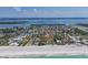 Bird's eye view of the home in a waterfront community with other residences near the beach at 5920 Gulf Of Mexico Dr, Longboat Key, FL 34228