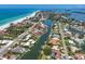 Expansive aerial view of waterfront properties, beaches, and canals in a coastal community at 5920 Gulf Of Mexico Dr, Longboat Key, FL 34228