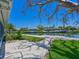 Beautiful backyard overlooking the canal, complete with a dock, lush landscaping, and inviting scenery at 5920 Gulf Of Mexico Dr, Longboat Key, FL 34228