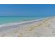 Scenic view of the beach with clear turquoise water meeting the sandy shore on a sunny day at 5920 Gulf Of Mexico Dr, Longboat Key, FL 34228