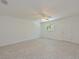 Bright bedroom with terrazzo floors, white walls, ceiling fan and a sunny window at 5920 Gulf Of Mexico Dr, Longboat Key, FL 34228
