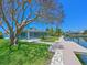 Charming blue home featuring a screened lanai and lush landscaping, near a tranquil canal at 5920 Gulf Of Mexico Dr, Longboat Key, FL 34228