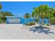 Charming single-story blue home with a well-manicured front yard, rock landscaping and a 1-car garage at 5920 Gulf Of Mexico Dr, Longboat Key, FL 34228