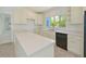 Bright kitchen boasts an island and ample counter space for food preparation and gathering at 5920 Gulf Of Mexico Dr, Longboat Key, FL 34228