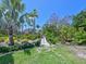 Pathway lined by lush landscaping and greenery, leading to a private residence, creating a serene entrance at 5920 Gulf Of Mexico Dr, Longboat Key, FL 34228