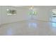 Bright living room with terrazzo floors, white walls, fan and natural lighting at 5920 Gulf Of Mexico Dr, Longboat Key, FL 34228