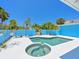 Inviting backyard pool and spa area, surrounded by tropical palm trees, perfect for relaxation and entertainment at 5920 Gulf Of Mexico Dr, Longboat Key, FL 34228