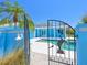 Gated pool area with tropical landscaping, stylish design, and a pristine, refreshing pool and hot tub at 5920 Gulf Of Mexico Dr, Longboat Key, FL 34228