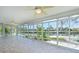 Bright sunroom with walls of glass, views of the canal and dock, and tile floors at 5920 Gulf Of Mexico Dr, Longboat Key, FL 34228