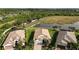 Aerial view of homes with well-maintained landscaping, driveways, and a serene pond in the background at 5987 Snowy Egret Dr, Sarasota, FL 34238