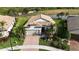 Lovely aerial view of home with clay tile roof, lake view, and beautiful landscaping in tropical community at 5987 Snowy Egret Dr, Sarasota, FL 34238