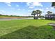 Beautiful backyard with lush green lawn and tranquil lake view at 5987 Snowy Egret Dr, Sarasota, FL 34238