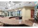 Beautiful bar with a granite countertop, dark mosaic tile, cabinets, and a sink, ideal for entertaining guests at 5987 Snowy Egret Dr, Sarasota, FL 34238