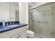 Bathroom featuring a blue granite countertop, white cabinets, and tiled shower at 5987 Snowy Egret Dr, Sarasota, FL 34238
