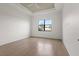 Bright bedroom with a tray ceiling, ceiling fan, and scenic outdoor view at 5987 Snowy Egret Dr, Sarasota, FL 34238
