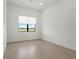 Bright, empty bedroom with neutral tile flooring and serene view at 5987 Snowy Egret Dr, Sarasota, FL 34238