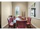 Meeting room with a dark wood table, six mauve chairs, artwork, and windows, perfect for meetings and collaboration at 5987 Snowy Egret Dr, Sarasota, FL 34238