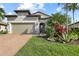 Charming single Gathering home with a brick paved drive, well maintained lawn, and elegant landscaping at 5987 Snowy Egret Dr, Sarasota, FL 34238