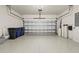 Wide garage with epoxy flooring and two overhead doors, providing ample parking space at 5987 Snowy Egret Dr, Sarasota, FL 34238