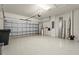Spacious garage with epoxy flooring and overhead door, perfect for parking and storage at 5987 Snowy Egret Dr, Sarasota, FL 34238