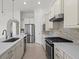 Bright kitchen with stainless steel appliances, quartz countertops, and stone backsplash at 5987 Snowy Egret Dr, Sarasota, FL 34238