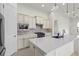 Modern kitchen featuring stainless steel appliances, stone backsplash, and a spacious island at 5987 Snowy Egret Dr, Sarasota, FL 34238