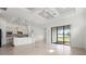 Spacious open-concept living area with a gourmet kitchen and sliding glass doors to the outside at 5987 Snowy Egret Dr, Sarasota, FL 34238