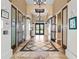 Elegant lobby features decorative tile flooring, arched entryway, chandelier, and access to the community center amenities at 5987 Snowy Egret Dr, Sarasota, FL 34238