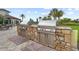 Outdoor kitchen featuring stainless steel grills, stone accents, and counter space at 5987 Snowy Egret Dr, Sarasota, FL 34238