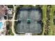 Aerial view of tennis courts, surrounded by lush greenery, offering a great recreational amenity at 5987 Snowy Egret Dr, Sarasota, FL 34238