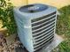 An outdoor A/C unit installed on a concrete slab with foliage surrounding it at 6113 Mckee St, Port Charlotte, FL 33981