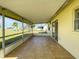 Enclosed back porch area featuring tiled floors and a lovely view of the yard at 6113 Mckee St, Port Charlotte, FL 33981